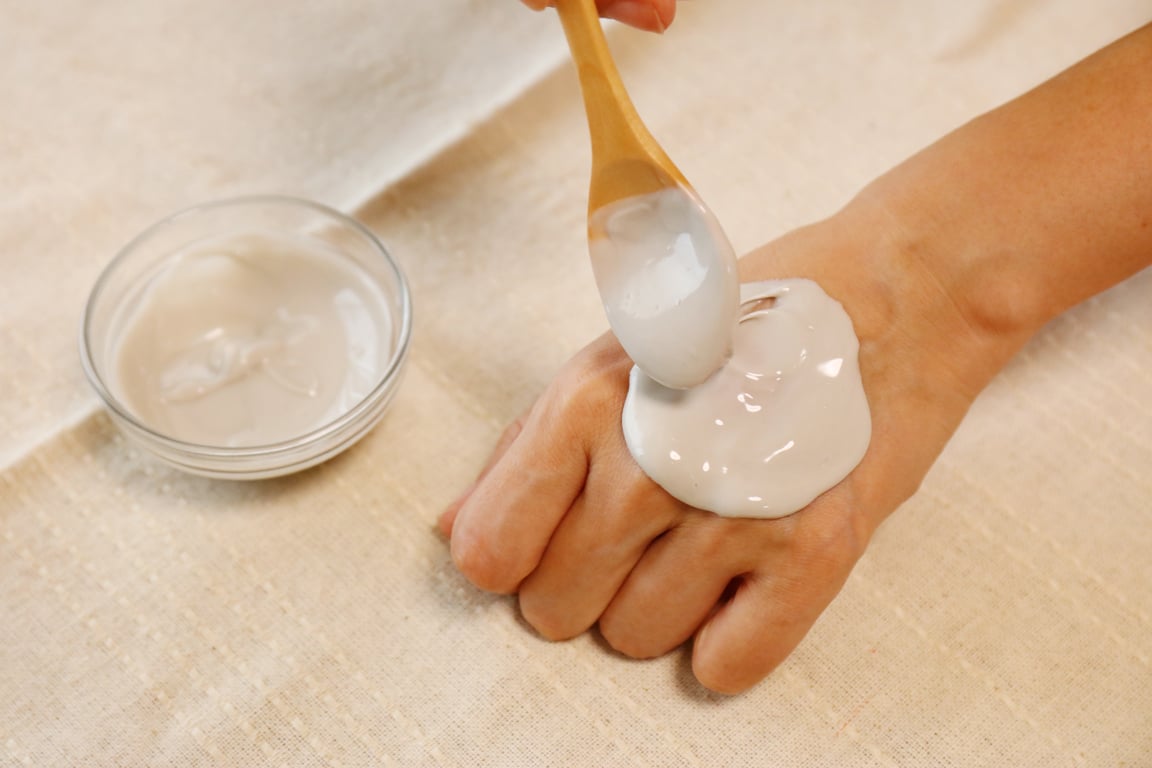 Women painting clay pack in hand